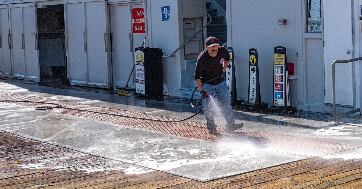 High pressure cleaning on a concrete driveway