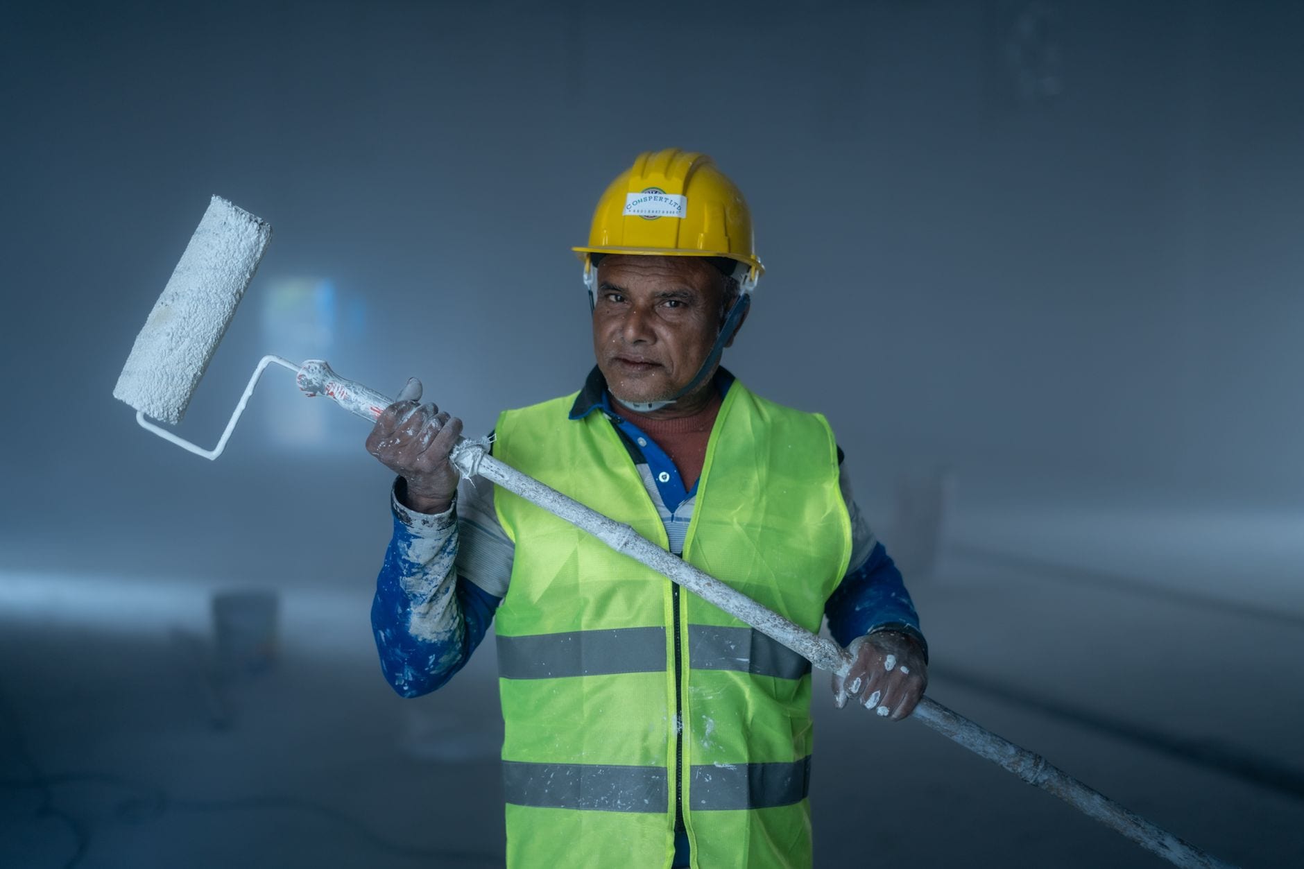 Commercial painting tools and equipment laid out on a job site.